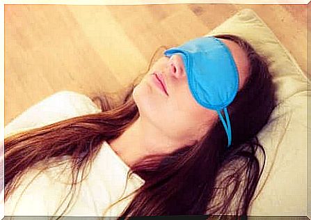 A woman sleeping with a sleeping mask