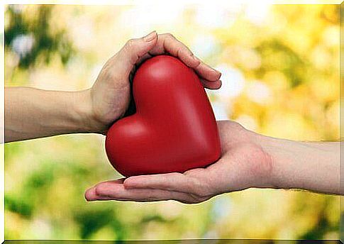 Two hands holding a heart