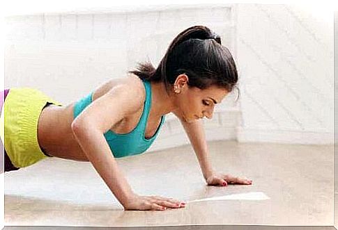 A woman who does push-ups.