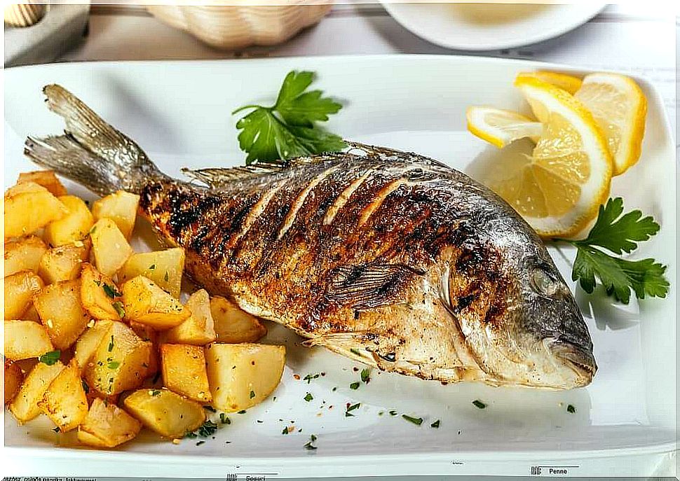 Delicious oven-baked sea bass with potatoes and onions