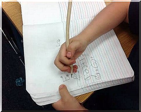 A child practicing spelling.