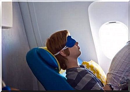 A person sleeping on a plane