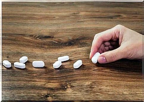 A person who puts pills on a table.