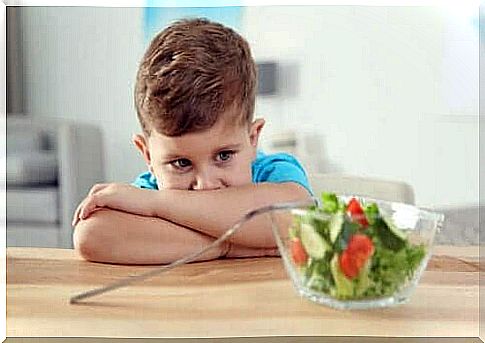 An autistic child who does not want to eat salad.